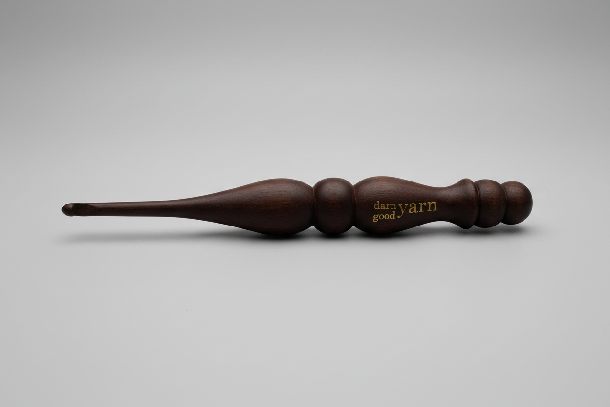 Brown wooden yarn swift on a white surface