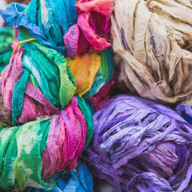 Ribbon made from reclaimed sari silk, sitting in a basket.