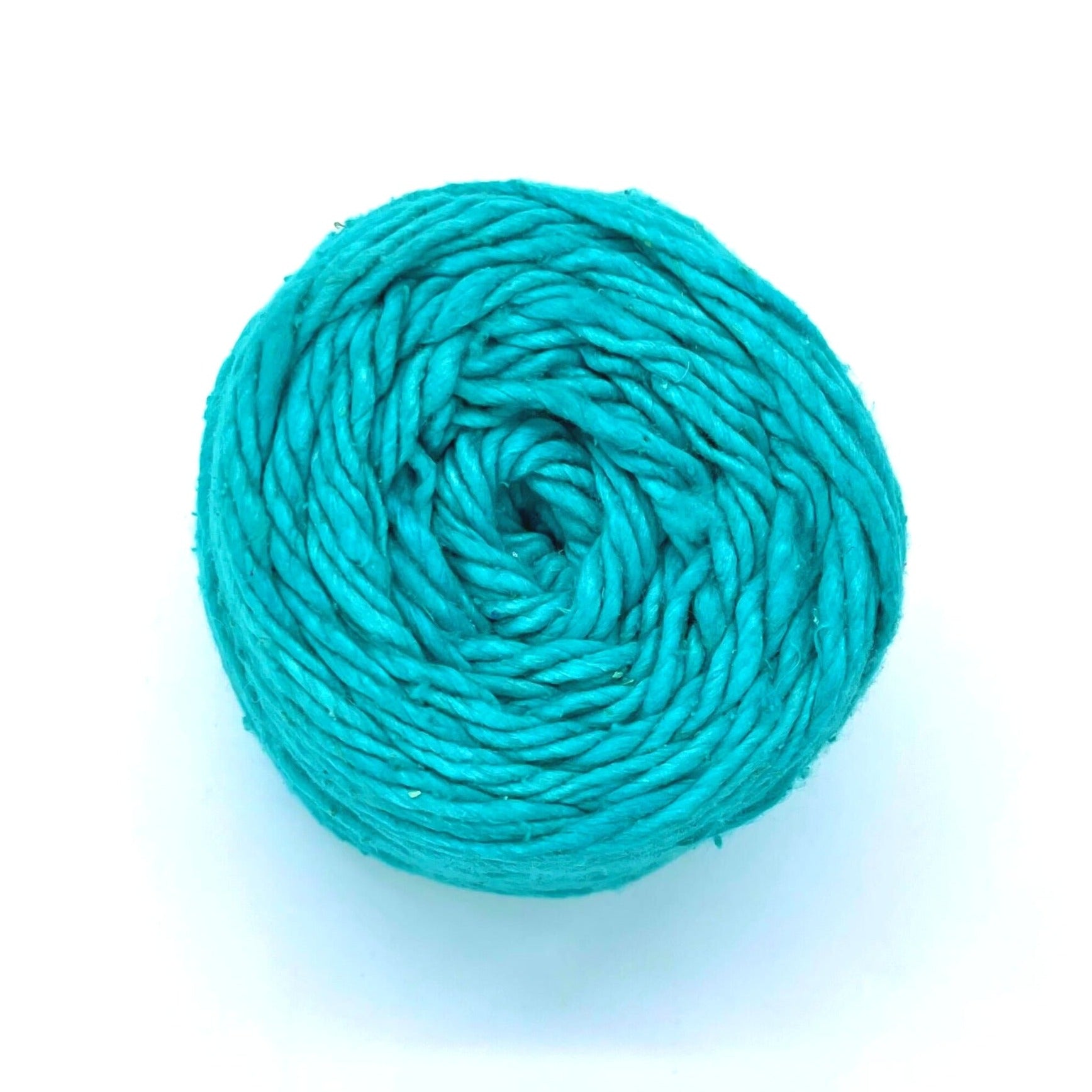 A skein of Tropical Season Worsted Weight Silk Yarn on a White Background.