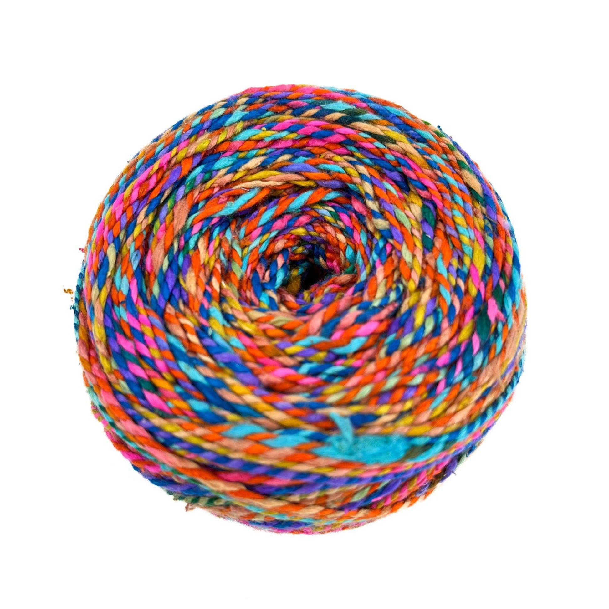 cake of sport weight silk in color way The Spice of Life. Red, blue, orange, and yellow marled yarn in front of a white background.