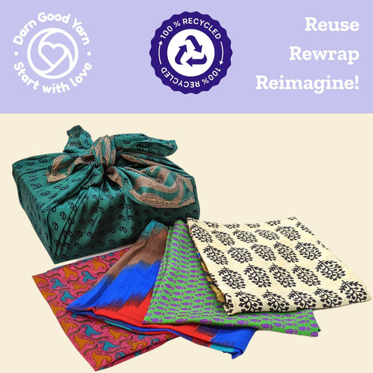 One box wrapped in Furoshiki gift wrap next to 4 Furoshiki laid on top of each-other on a cream backdrop. Top has darn good yarn logo and recycle logo with the words reuse, rewrap, reimagine.