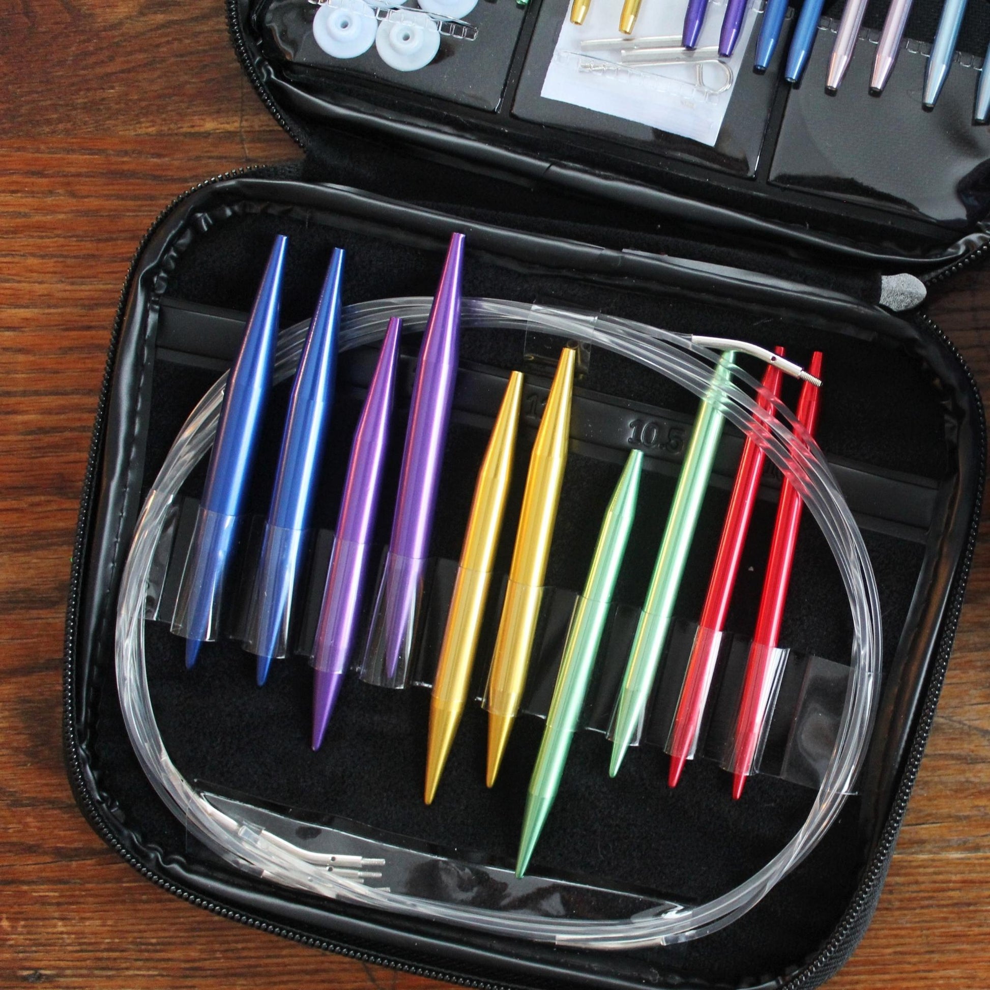 An up close view of some aluminum knitting needles in a travel pouch.