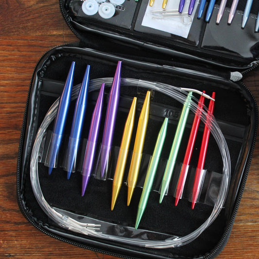 An up close view of some aluminum knitting needles in a travel pouch.