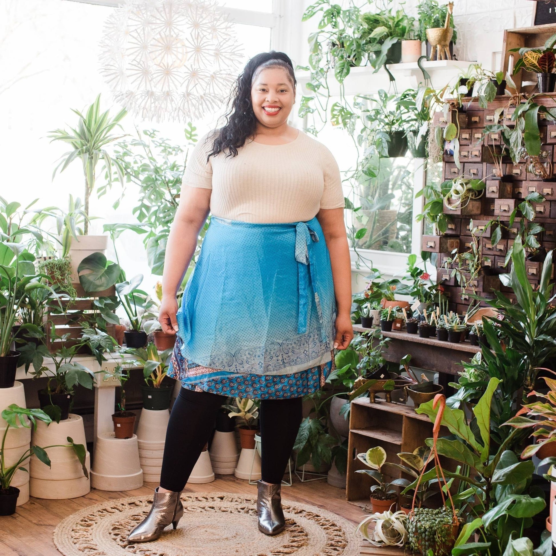 Model wearing a one of a kind light blue sari wrap skirt in goddess sizing.