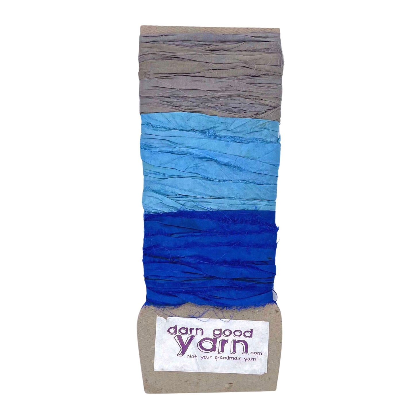 3 shades of sari silk ribbon yarn on a white background. 1 shade of grey, 1 shade of light blue and one shade of cobalt blue