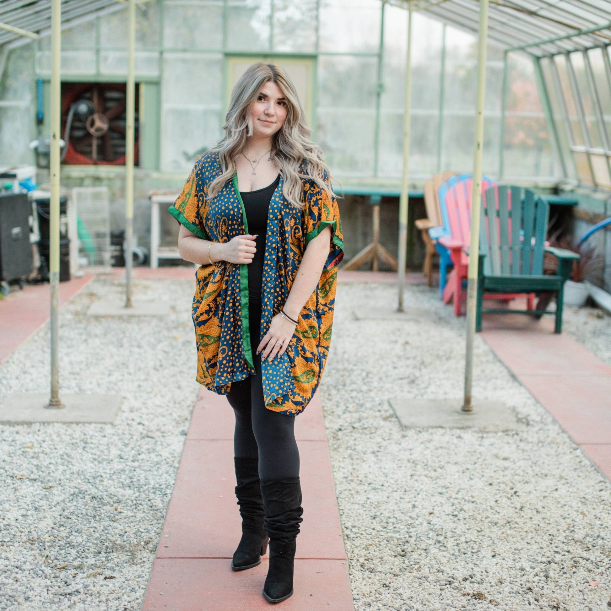 Model is standing in a greenhouse wearing a mustard yellow amara short duster.