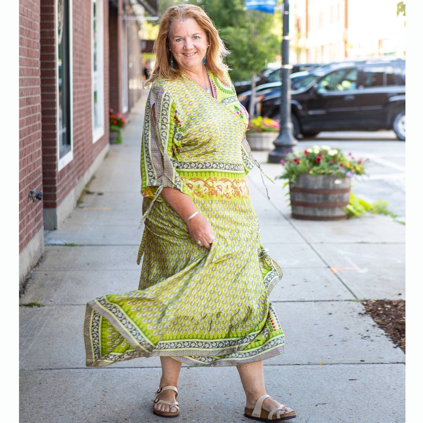 Model is walking down the street wearing a light green Zaria.