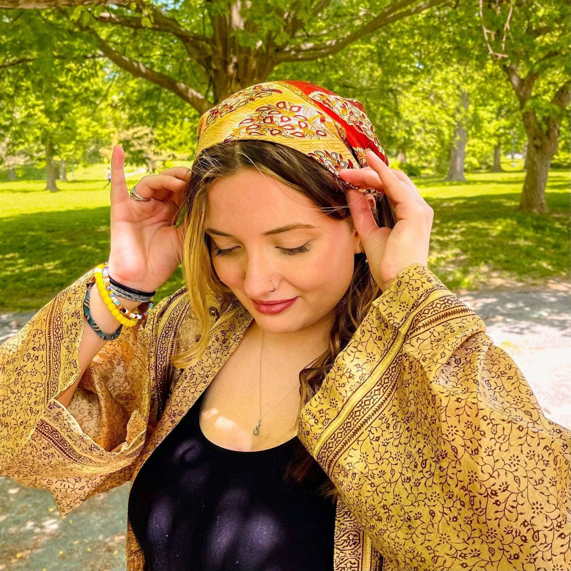 Model is in the park wearing a yellow Furoshiki in her hair.