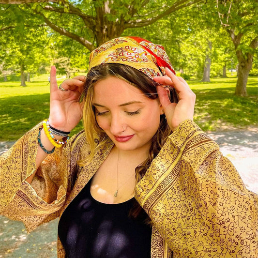 Model is in the park wearing a yellow Furoshiki in her hair.