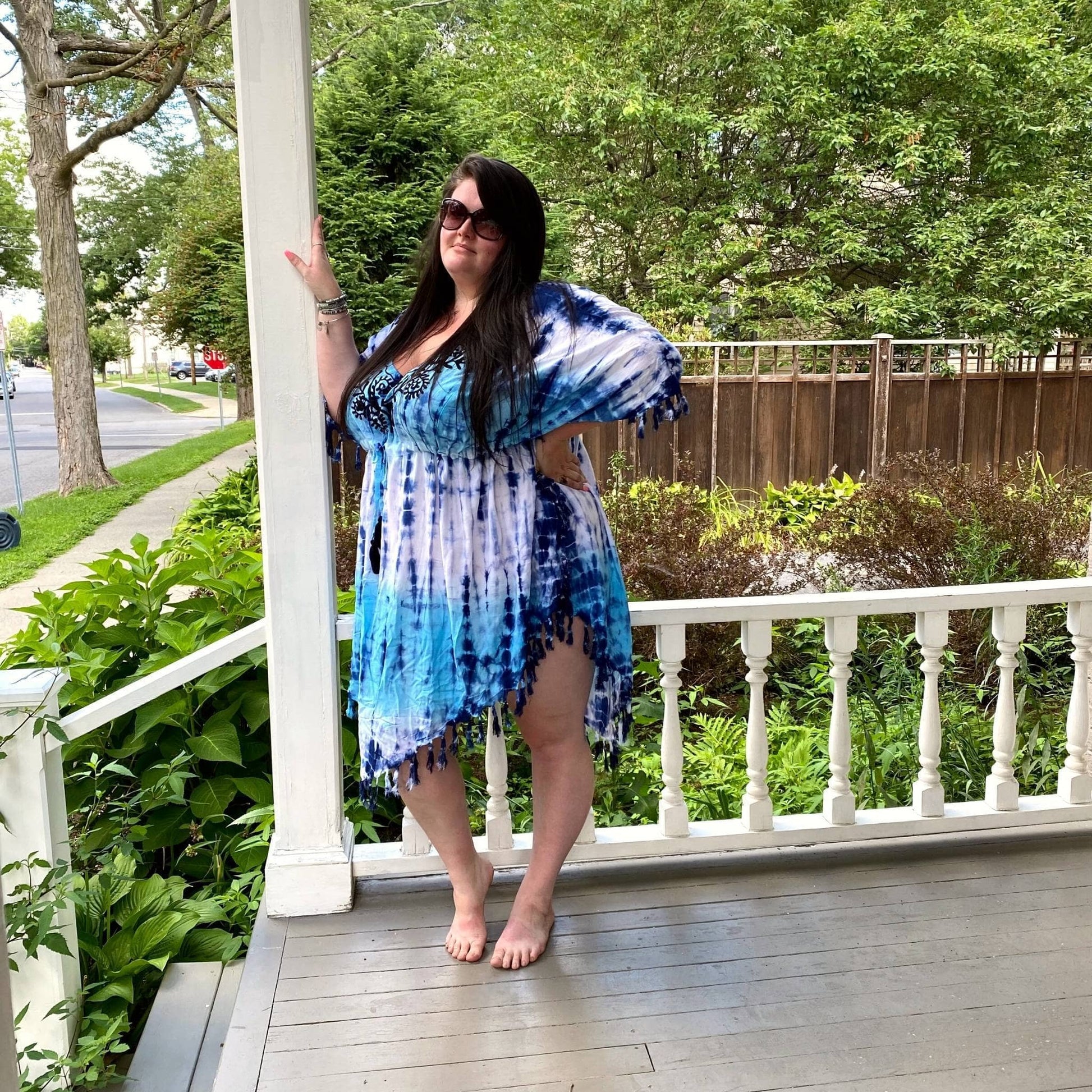 Model is wearing our goddess Dusky Tie Dye Cover Up while standing on a porch.