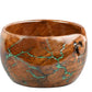 Brown bowl with green vein-like design and a thread-cutout curve.