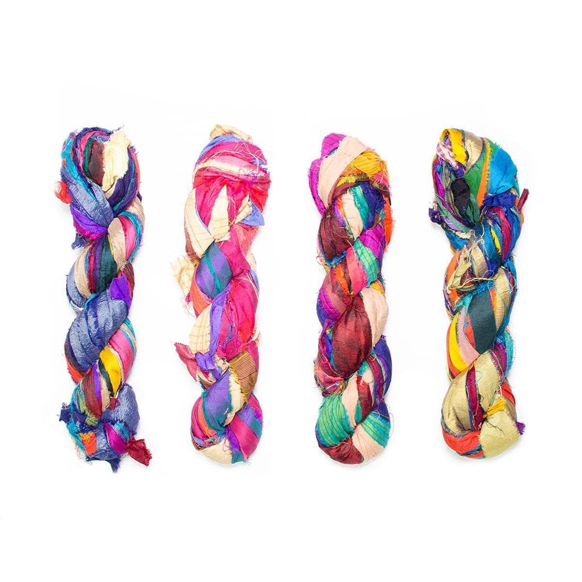 4 skeins of sari silk ribbon yarn in the base at the Bahamas in front of a white background.
