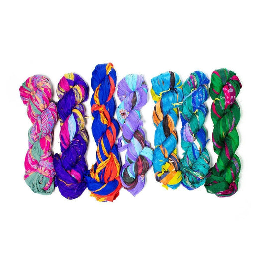 Jewel tone skeins of chiffon ribbon on a white background