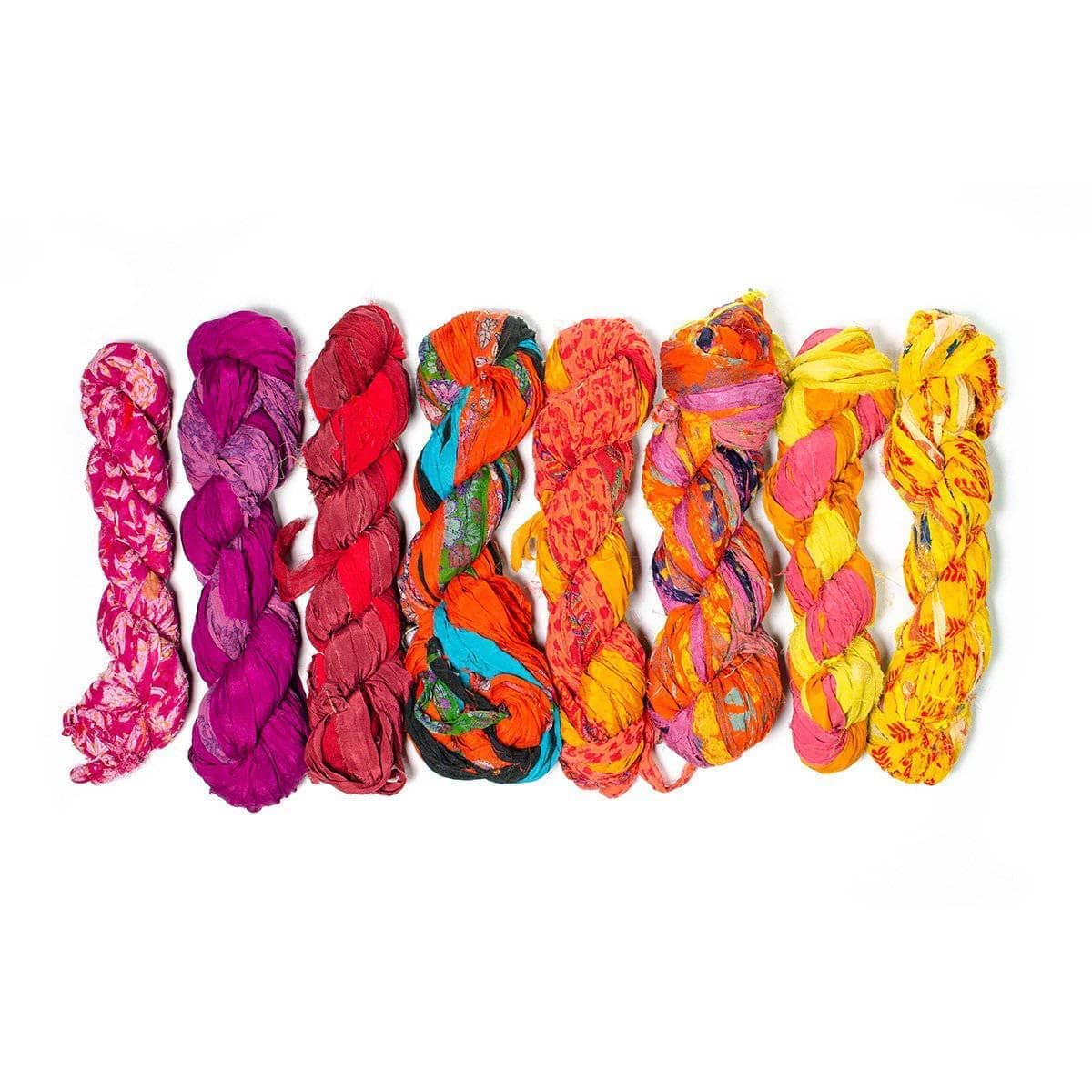 Pink, orange, yellow skeins of chiffon ribbon on a white background