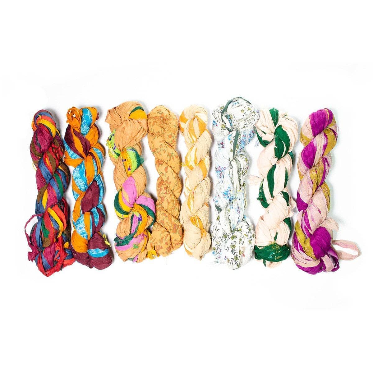 white, pale yellow, and beige colored skeins of chiffon ribbon on a white background