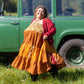 Woman wears yellow and orange tone sedona dress