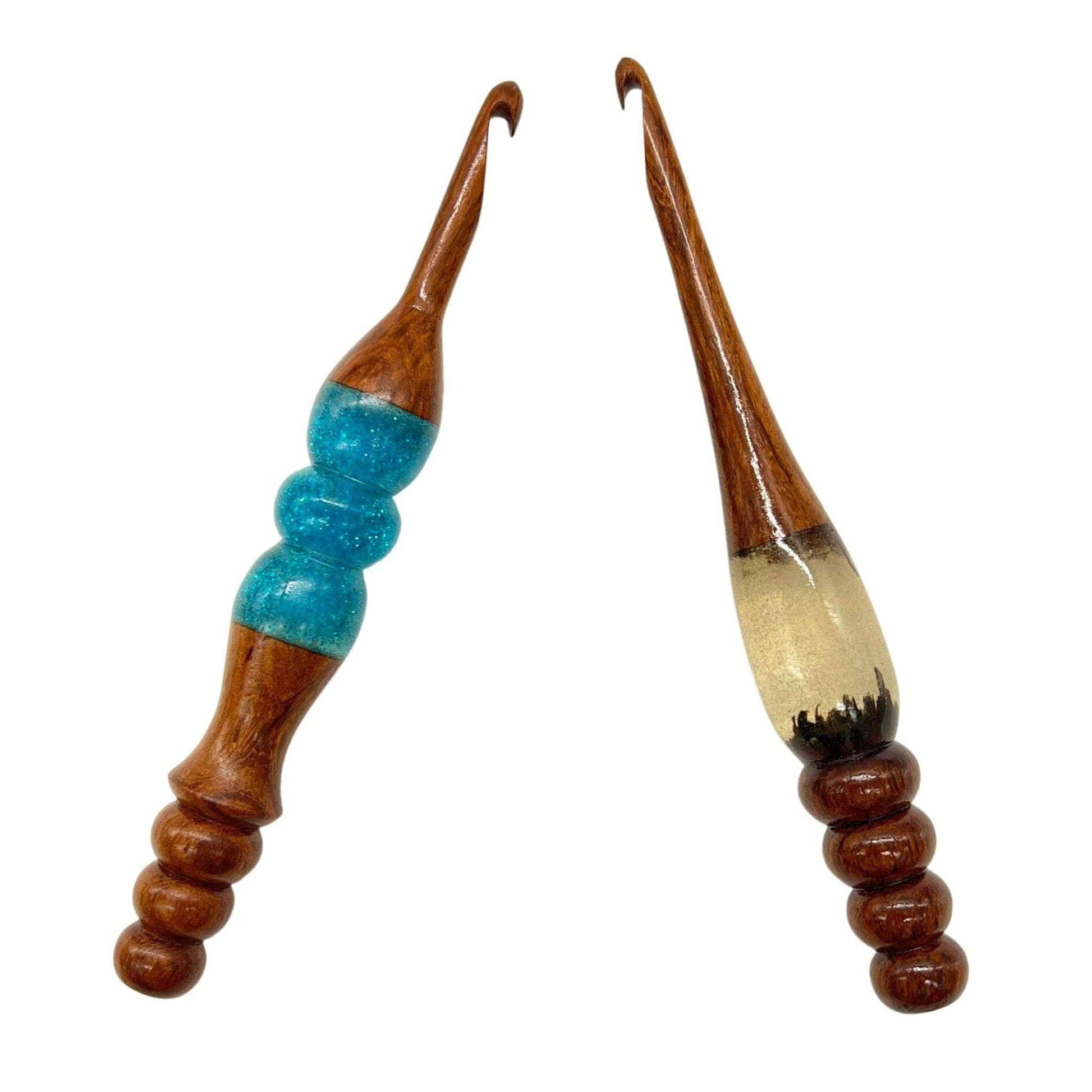 Two wooden and resin crochet hooks.