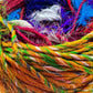 An upclose shot of 'Spice Market' Reclaimed Sari Silk Yarn. Showing the textures of the yarn.