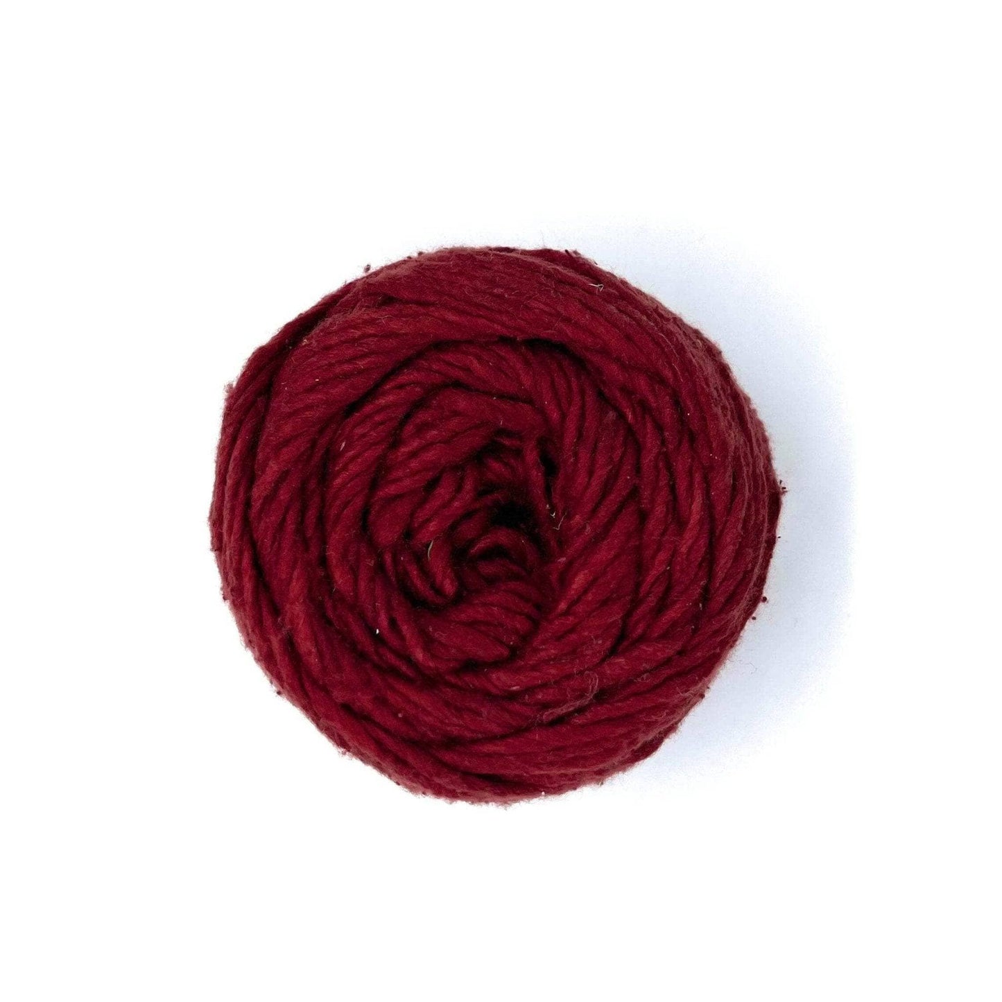 A neatly wound ball of dark red yarn on a white background.