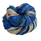 Twisted multicolored fabric strips in blue, beige, and red.