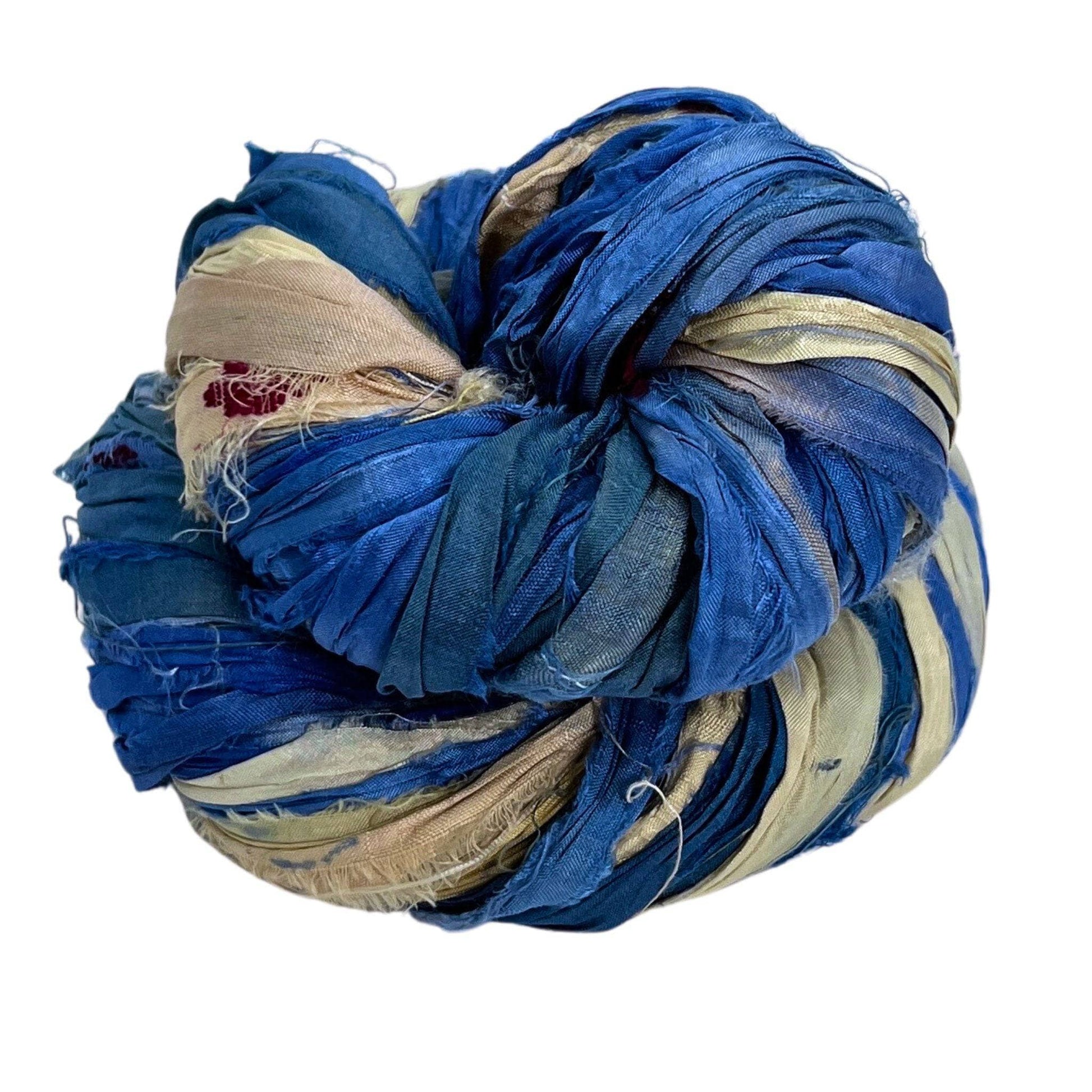 Twisted multicolored fabric strips in blue, beige, and red.