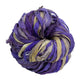 A used purple sari silk Yarn rolled.