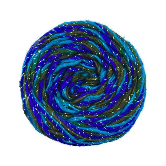 sparkle worsted weight roving silk yarn in variegated light blue, dark blue, green colorway.