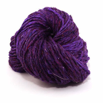 Spekcled Tweed Recycled Silk Yarn ball in Royal Purple on a white background