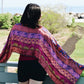 pink Medley scarf sitting on the back of models shoulders while they look into the distance. 
