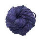 A tightly wound ball of dark purple silk ribbon yarn against a white background.