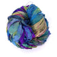 A multicolored ball of crinkled silk ribbons in blue, green, purple, and pink shades.