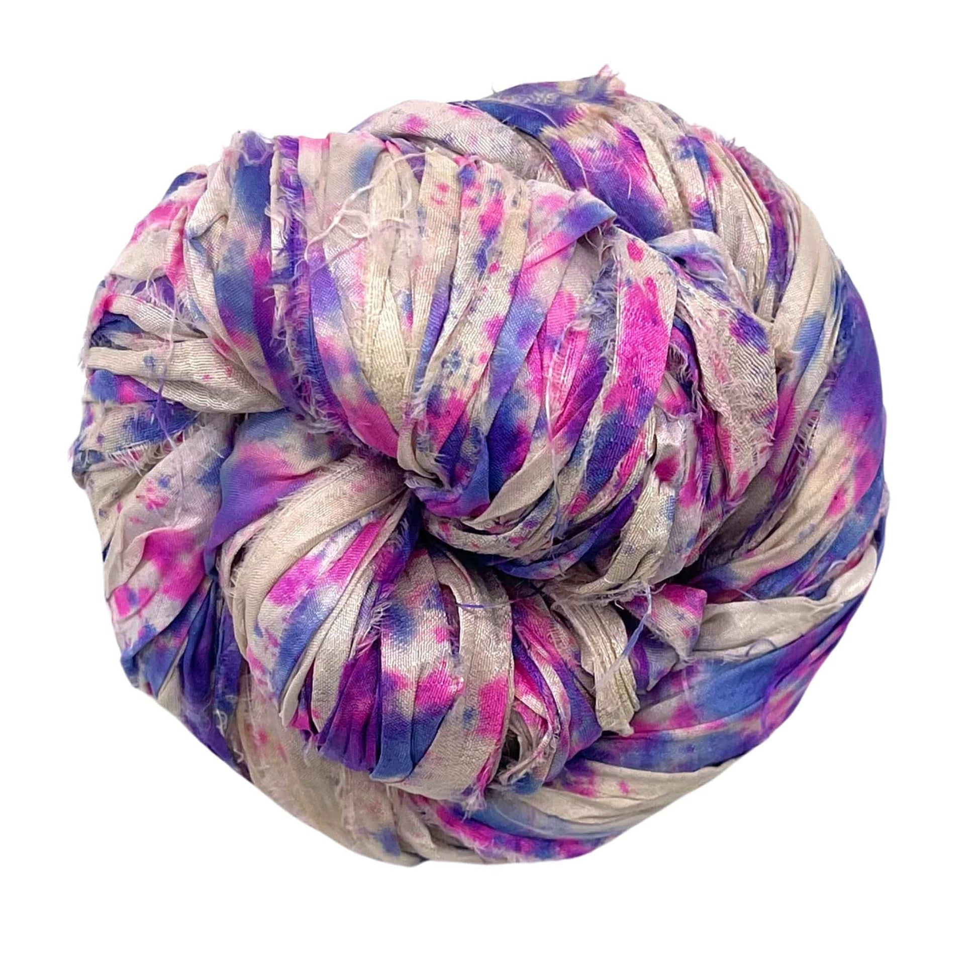 A coiled bundle of purple, pink, and beige fabric strips.