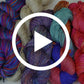 A hand beaded silk yarn with a play button in the middle.