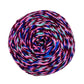 A skein of reclaimed silk yarn on a white background. The yarn is a triple ply yarn with dark plum, pink, turquoise navy and cobalt blue colors. 