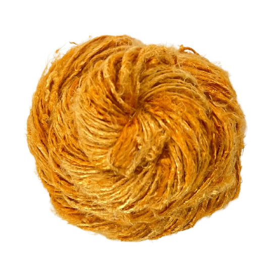 Top view of skein of Neon Yellow banana fiber yarn curled into a birds nest shape in front of a white background.