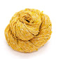 Yellow and white yarn with yellow beads and crystals throughout, sitting in front of a white background.