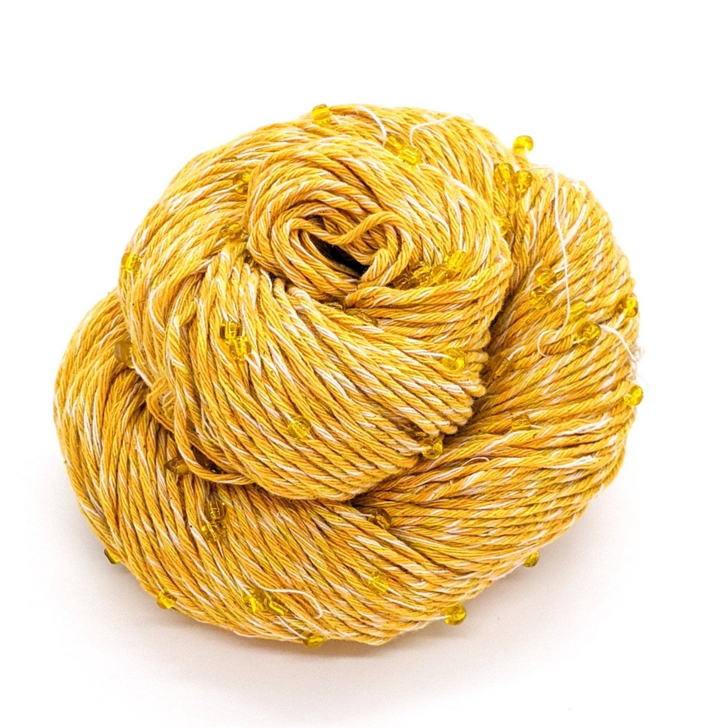 Yellow and white yarn with yellow beads and crystals throughout, sitting in front of a white background.