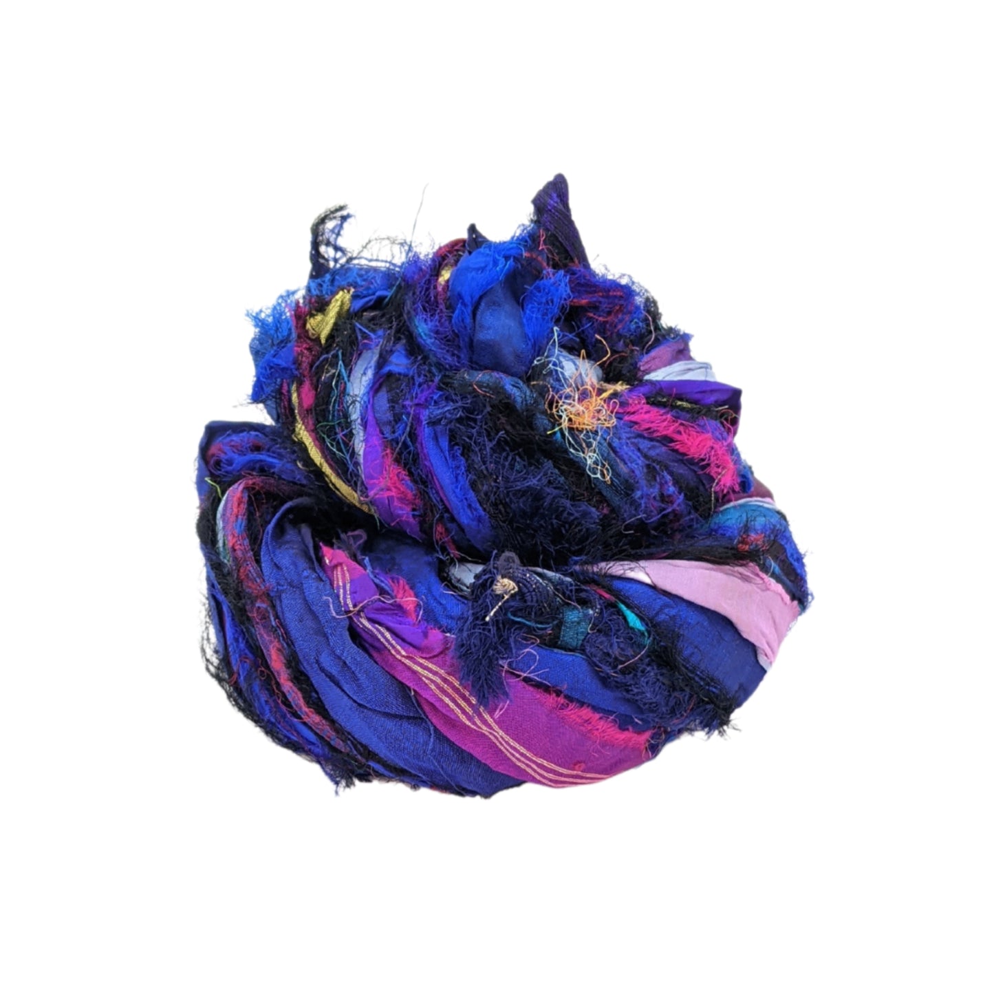 A side view of Windswept Sari Silk Ribbon in Indigo colors on a white background. The ribbon is made into a birds nest to show the different colorways. Indgio Windswept includes rich purples and blues to blacks and pinks.