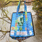 Recycled rice tote with river and trees in the background.