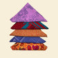 Five Furoshiki folded in triangles on a cream backdrop. 