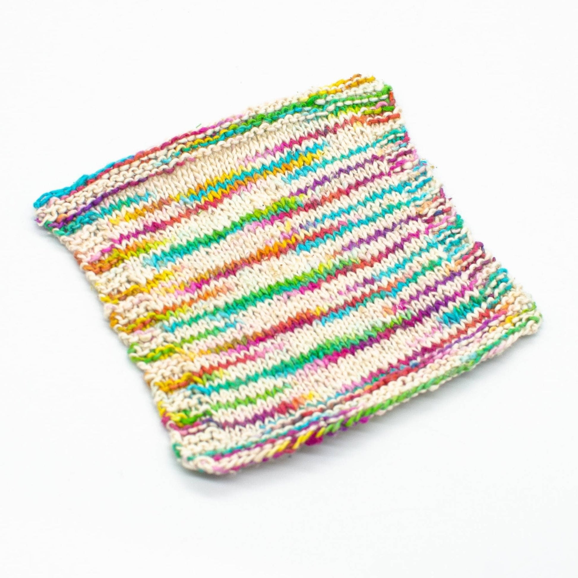 knit swatch of unicorn cloud peek a boo lace weight silk yarn (white and rainbow)
