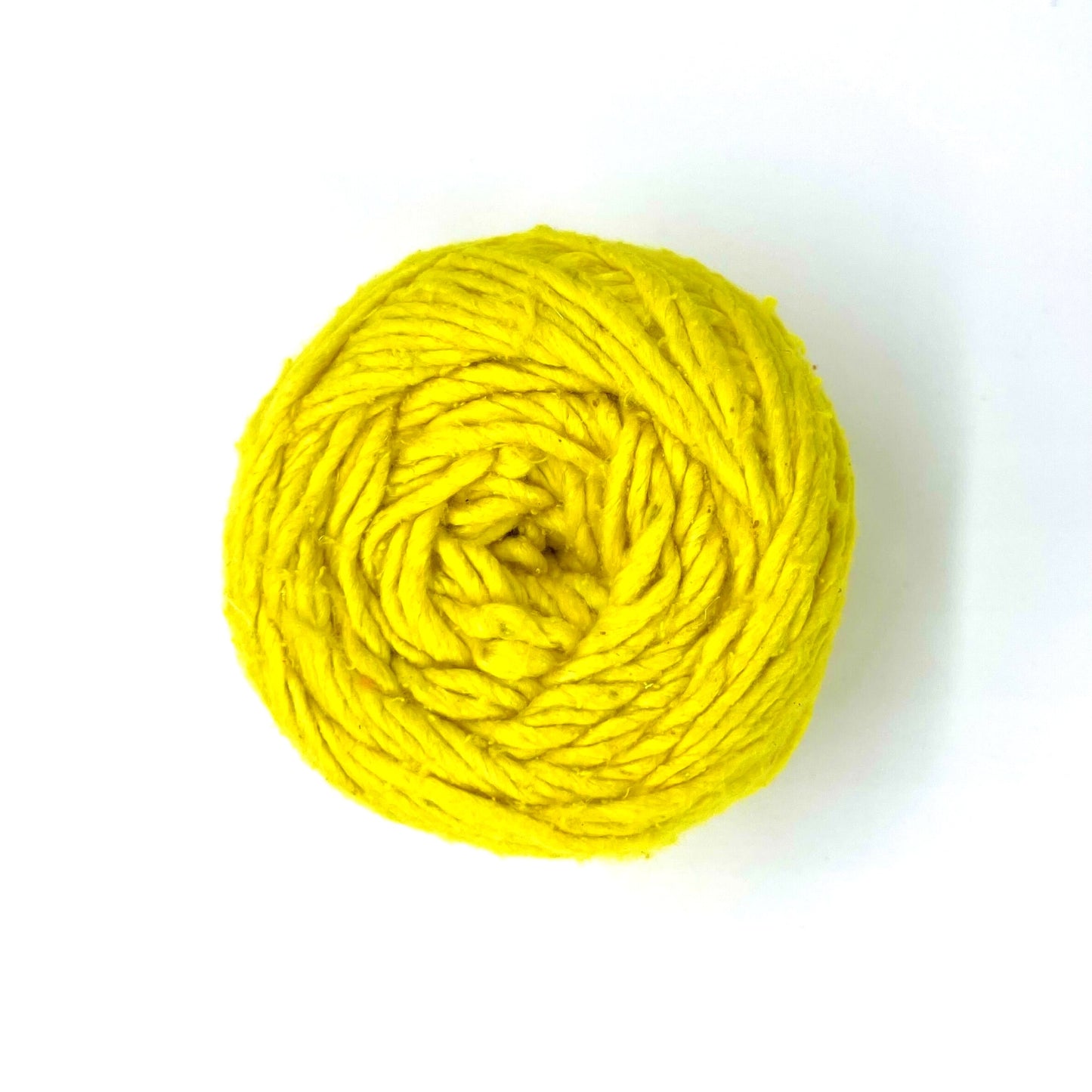 A skein on yellow worsted weight silk yarn called "Illuminating" on a white background.