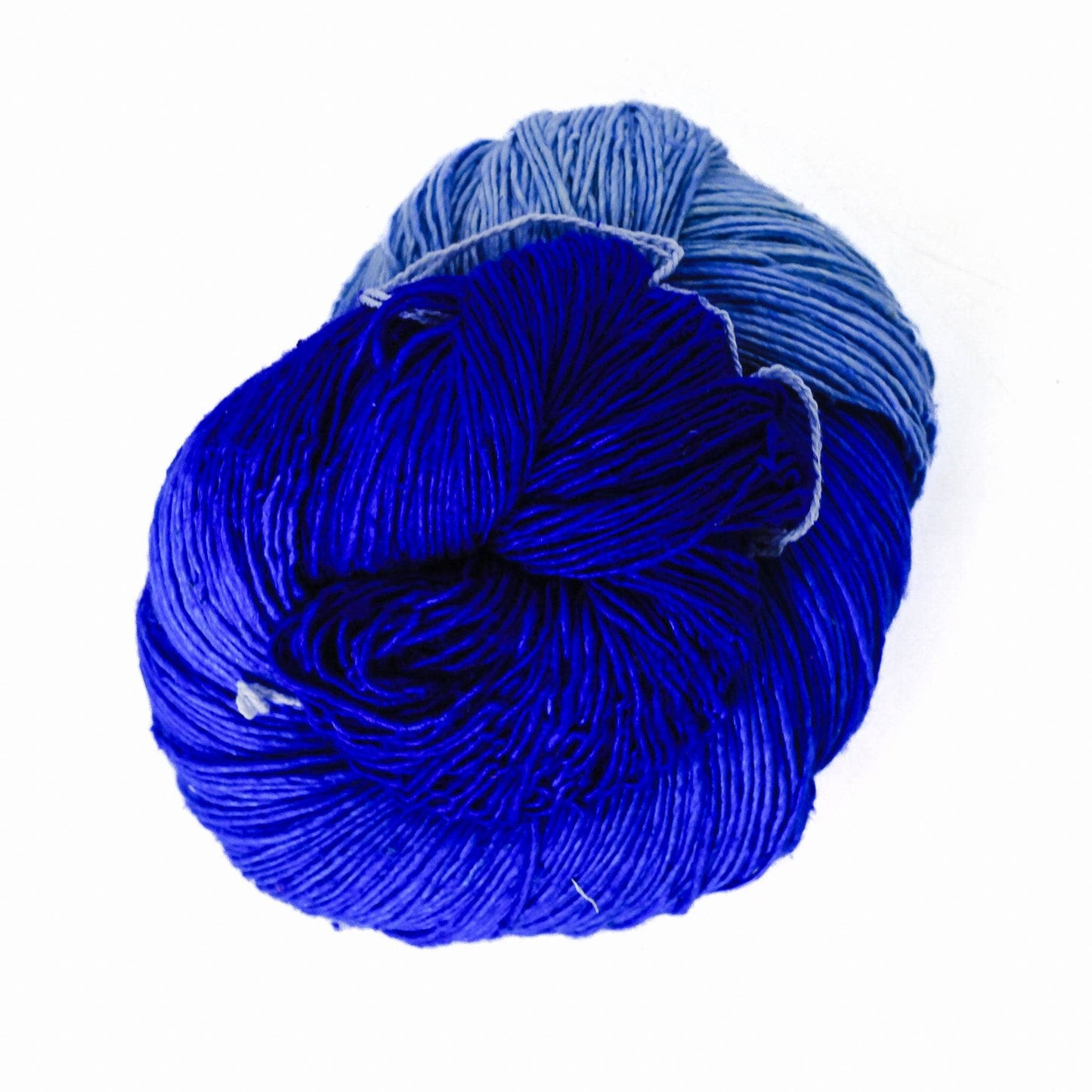 variegated ombre lace weight blue in front of a white background.