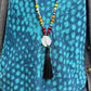 Closeup picture of Chakra & Sandalwood Beaded Necklace on model.