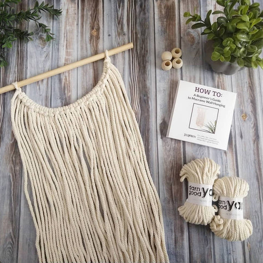 DIY Macrame Wall Hanging on a wood backdrop.