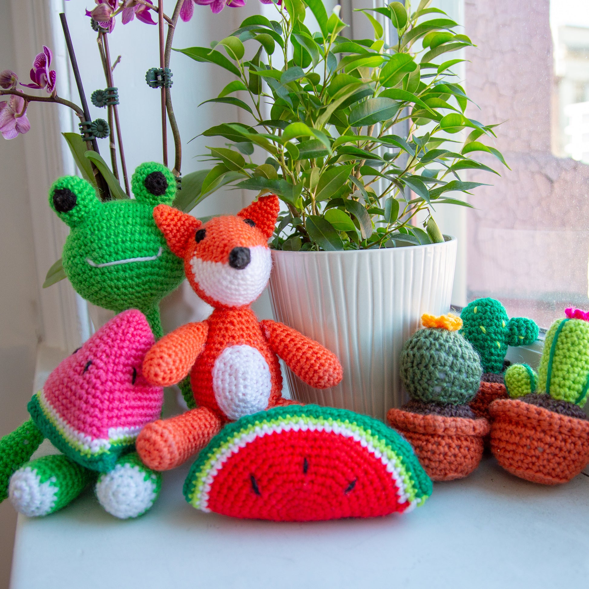 DIY Stuffed Animal Knit & Crochet Kit Packs next to a plant. 