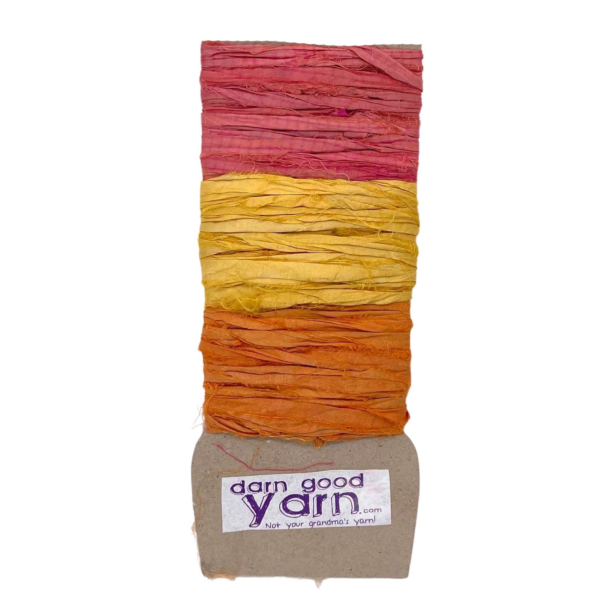 3 shades of sari silk ribbon yarn on a white background. 1 shade of pink, 1 of yellow and one orange