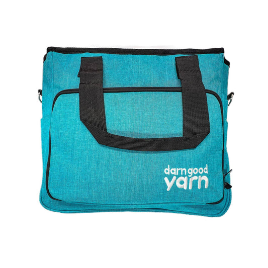 A teal crafters storage bag with the darn good yarn logo on a white background.