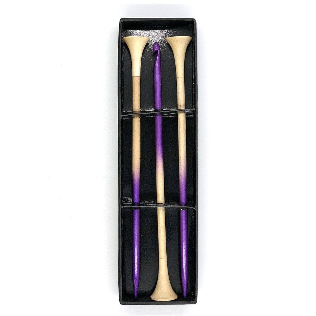 A package containing purple ombre dyed bamboo knitting needles and a crochet hook.