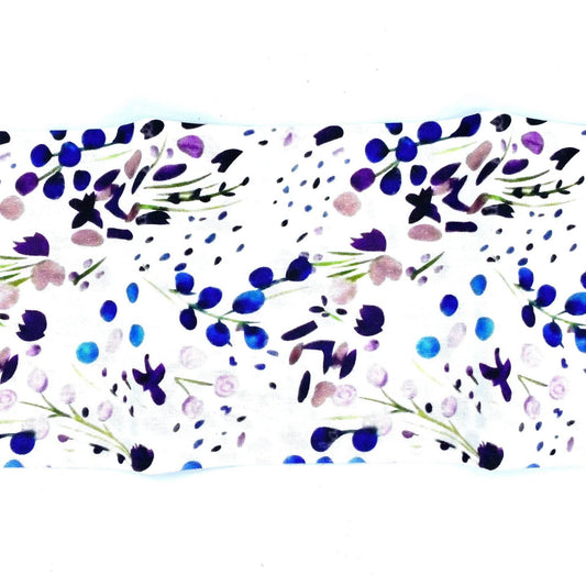 Spring florals print, shades of blue to purple and pink flowers with green stems and some dots with white background.